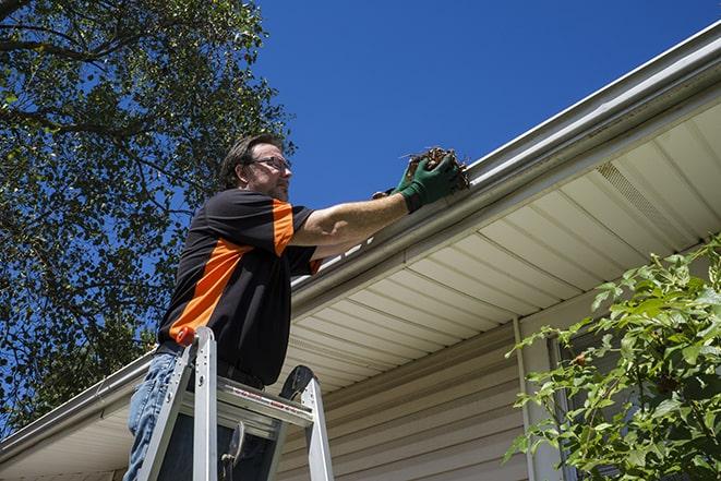 a man repairing a gutter on a residential home in Arbuckle CA